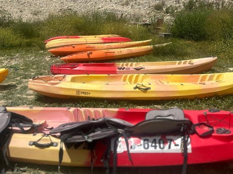 Person paddling a kayak on the crystal-clear waters of the Guadalest reservoir